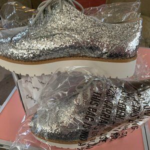 Brand new. Qupid Newbie Silver Glitter size 5.5